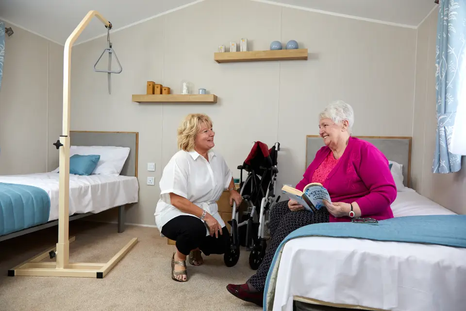 Woman with mobility difficulties in a Willerby caravan with carer