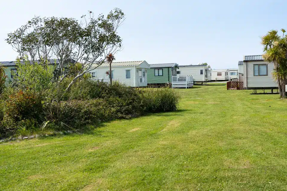 Elderly couple enjoying drinks on their caravan decking at Eryl Hall Holiday Park