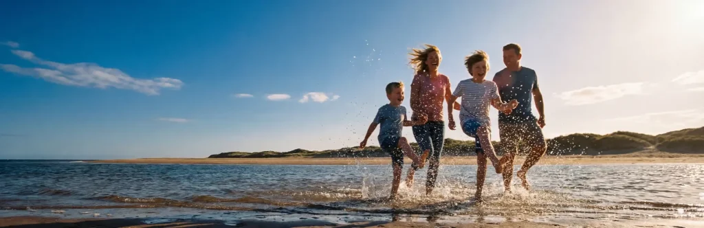 Family enjoying the North Wales coast during their summer holidays 2026