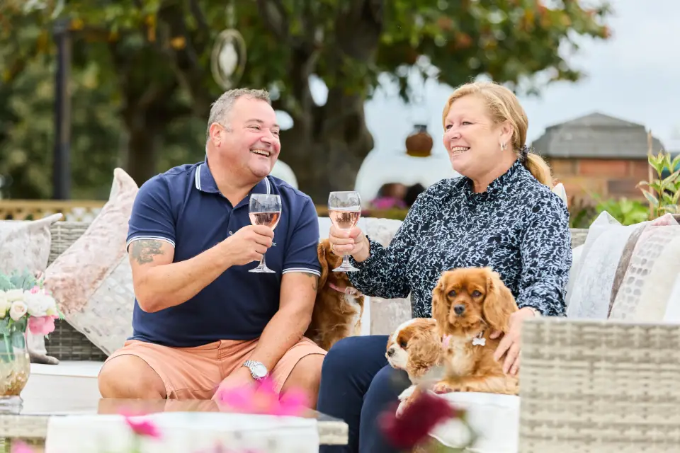 Owners enjoying wine on their caravan decking