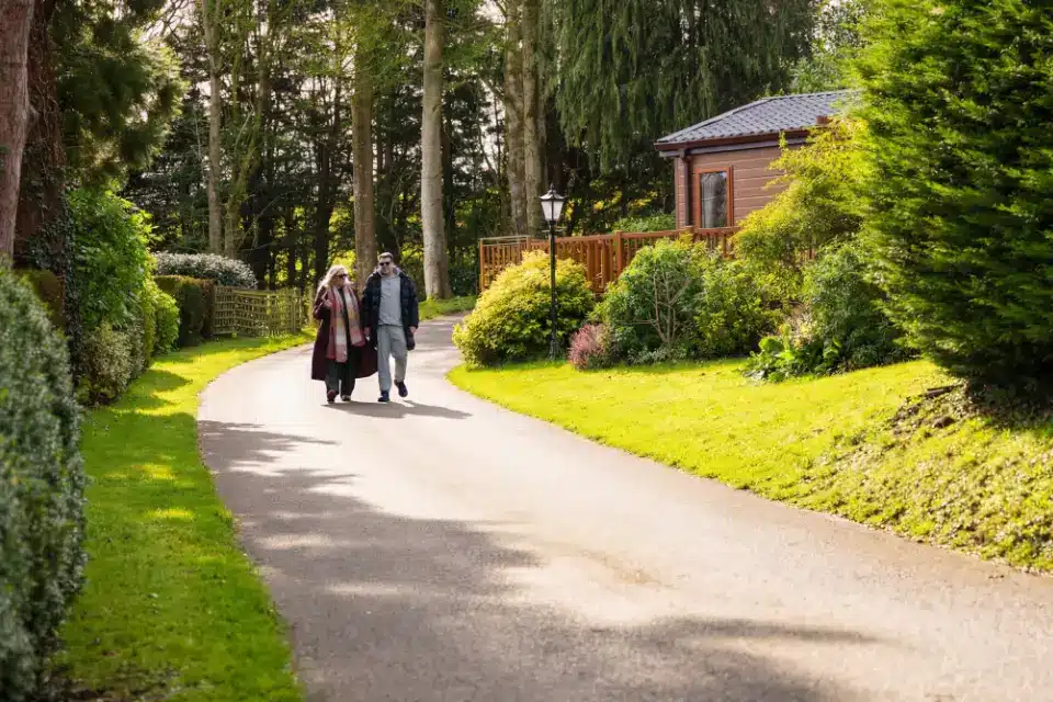 Couple walking into Woodlands Hall holiday park in Ruthin