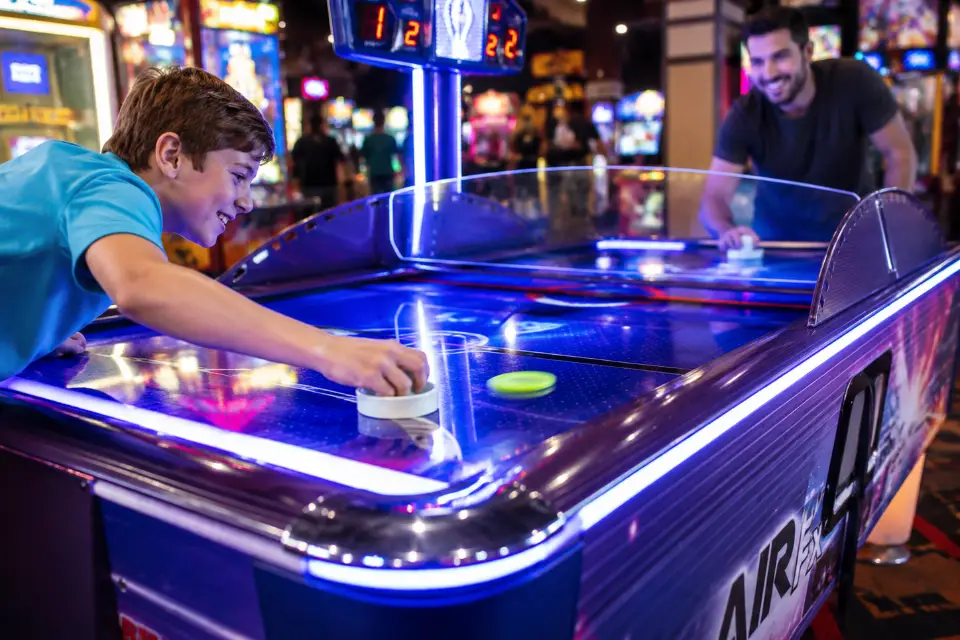 Playing air hockey in Lyons arcades