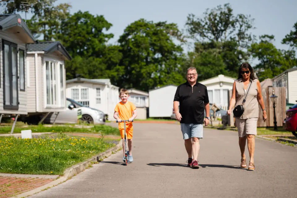 Family walking around the grounds after buying a caravan for sael at Eryl Hall