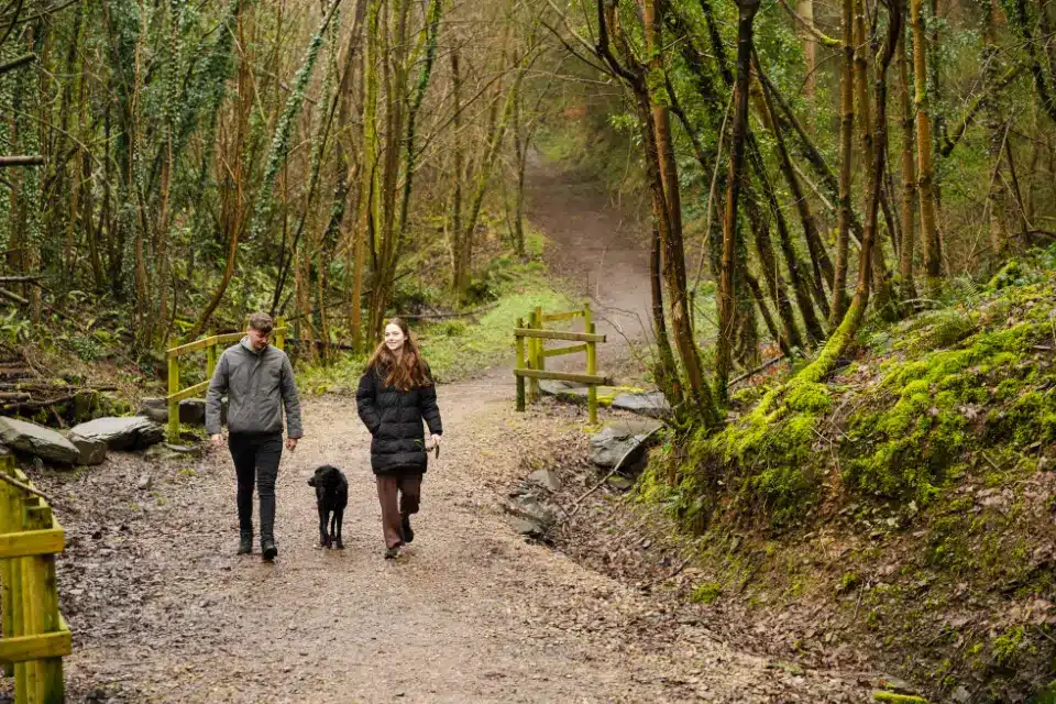 Couple walking through loggerheads with their dog near Woodlands Hall Holiday Park in Ruthin
