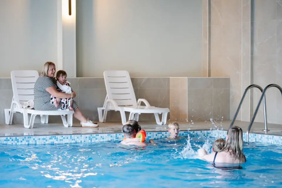 Family enjoying time in the swimming pool over October half term breaks
